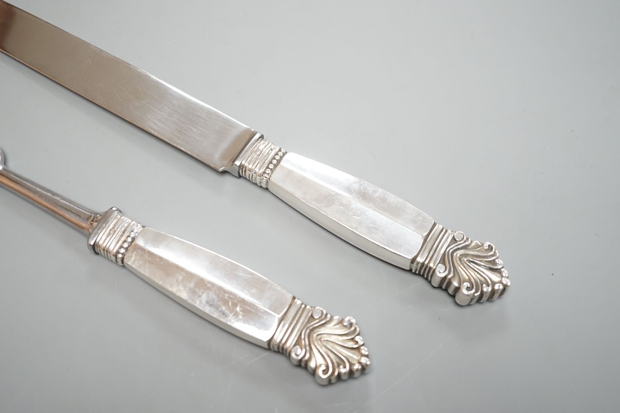 A pair of Georg Jensen sterling handled carving knife and fork, knife 34.4cm.